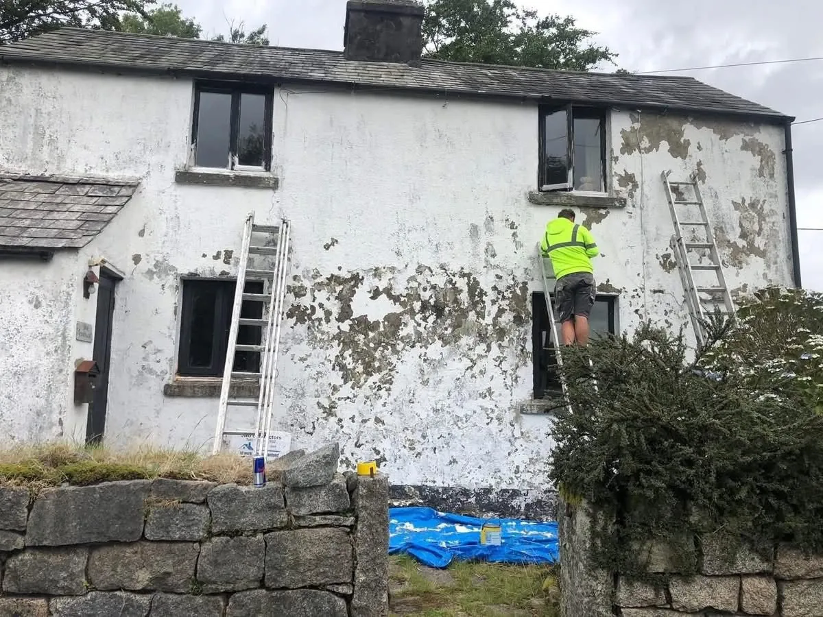 Cottage with blown, flaking render before repair in Penryn